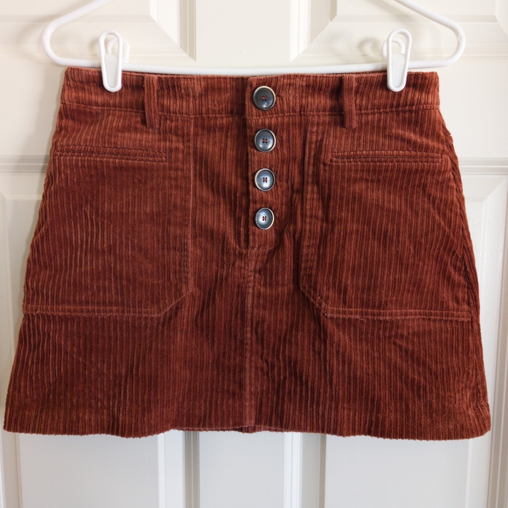 Rust corduroy mini skirt with front buttons and front pockets